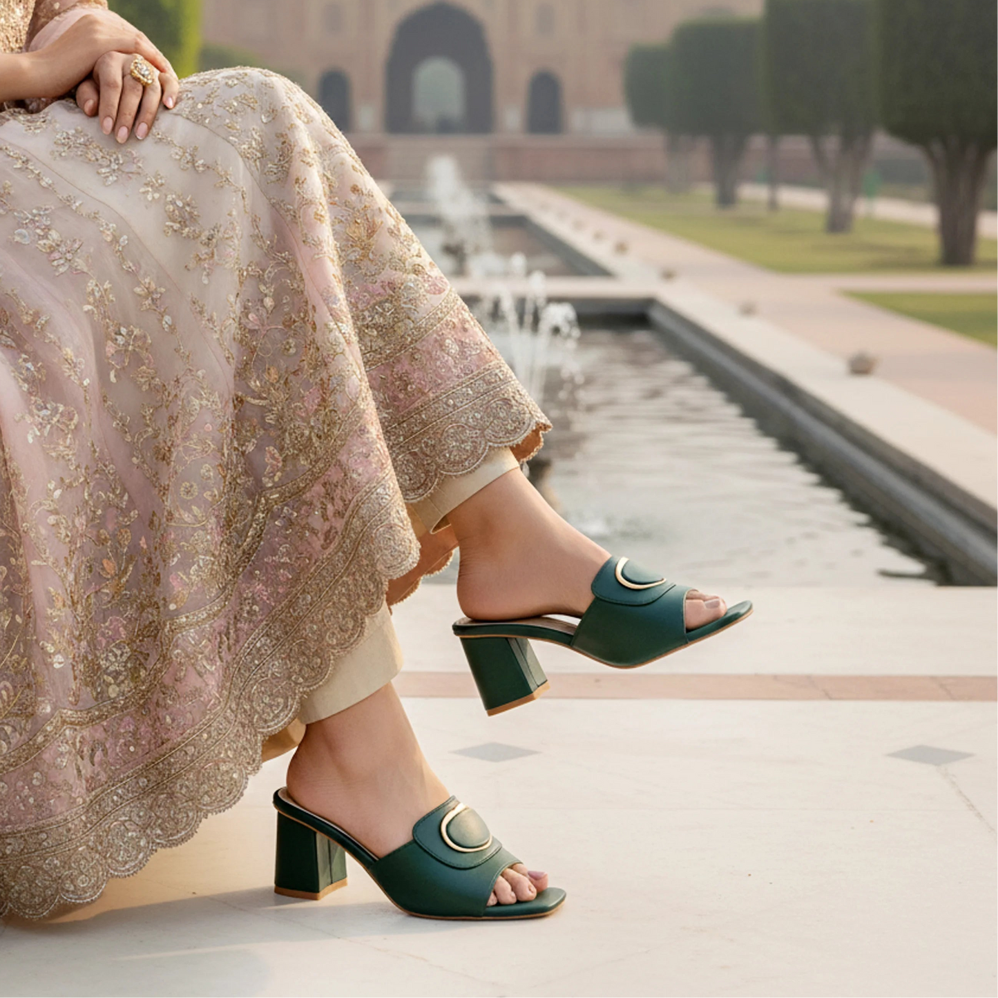 Person wearing green sandals with a traditional outfit in an outdoor setting