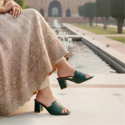 Person wearing green sandals with a traditional outfit in an outdoor setting