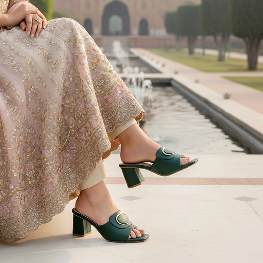 Person wearing green sandals with a traditional outfit in an outdoor setting